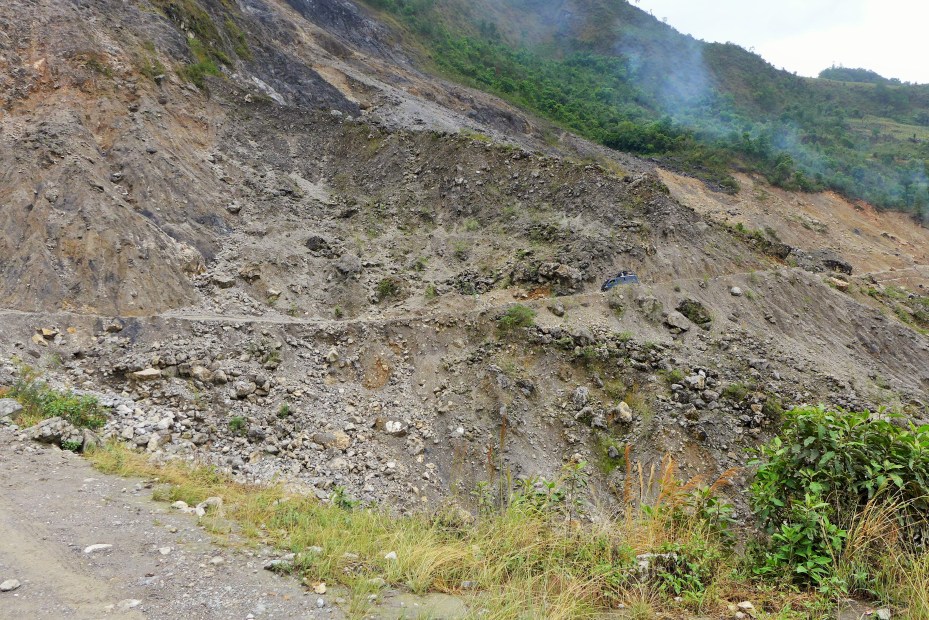 A land slide that not long ago had taken out the road. was now open but in rough shape