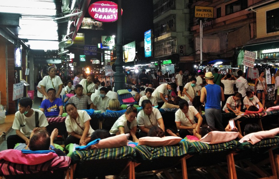 tourists getting foot massages
