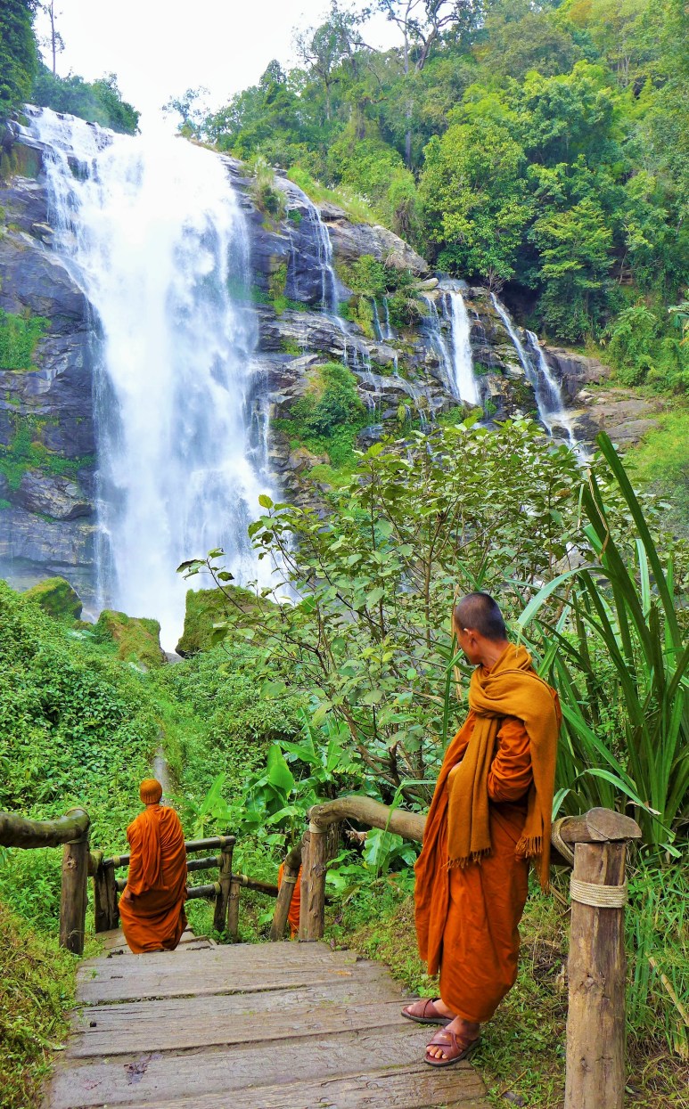 orange robed monks also admiring the falls 