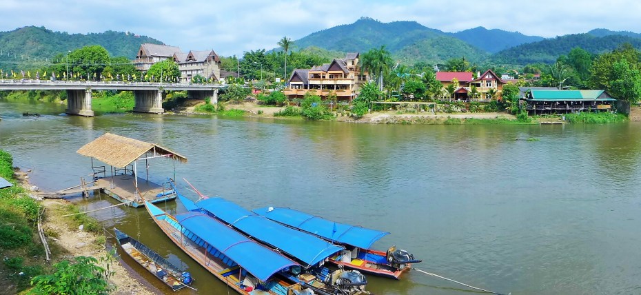 Long boats ready to transport travellers down the river Kok