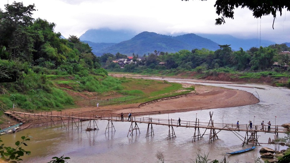a bamboo bridge river crossing in Luang Prabang